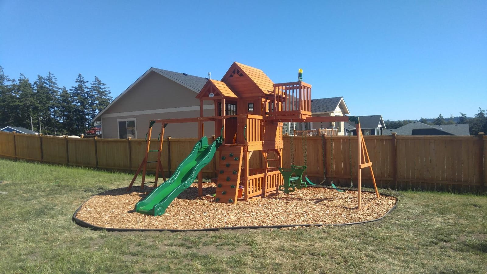 Backyard Discovery Skyfort II Cedar Wood Swing Set with Wave Slide, Raised Clubhouse, Crow's Nest, Monkey Bars, Balcony, Belt Swings, Trapeze, Rock Wall, Picnic Table, Sandbox, Ladder, Outdoor Playset customer photo 1